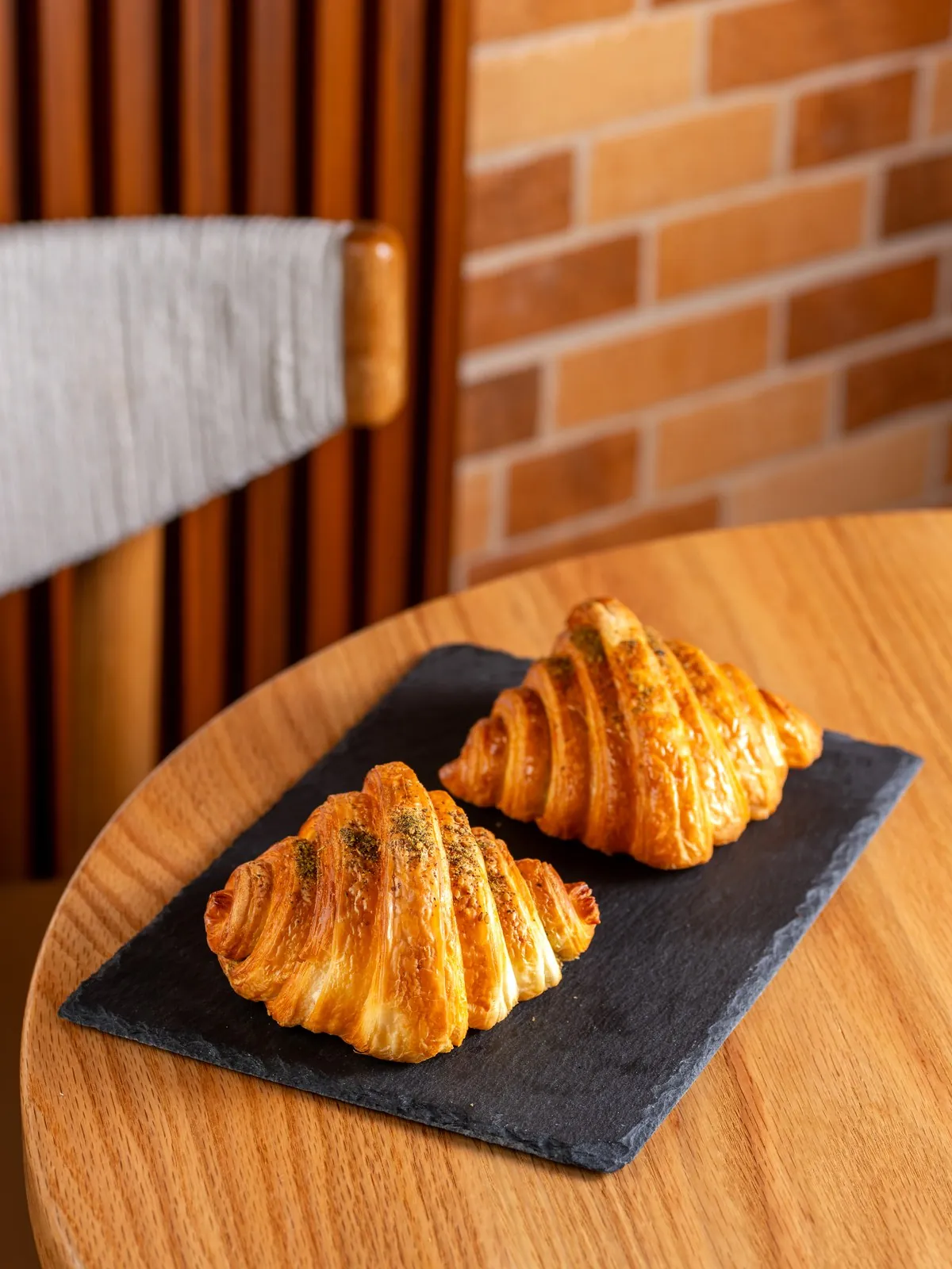 Two croissants on a slate board